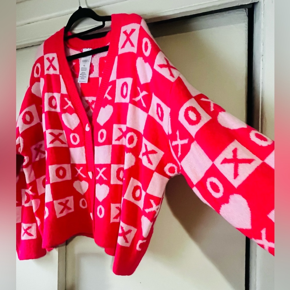 Pink and Red XO Women's waist length cardigan sweater with heart buttons.